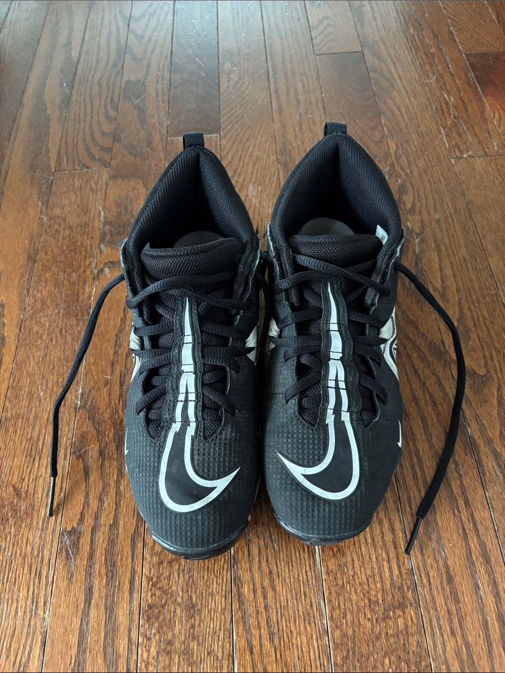 Nike Kids Black Football Cleats with White Swoosh Detailing